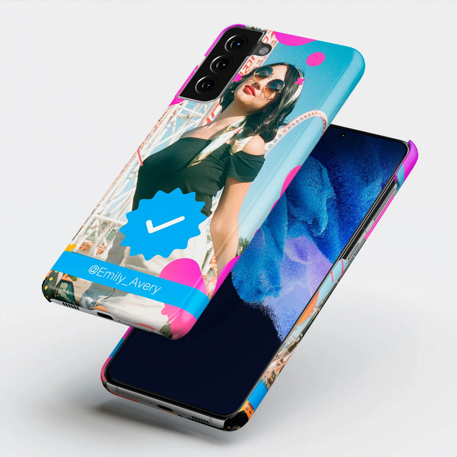 Wrappz phone case with personalised image of a woman in front of a rollercoaster, and a verified blue tick symbol and twitter handle over the image.